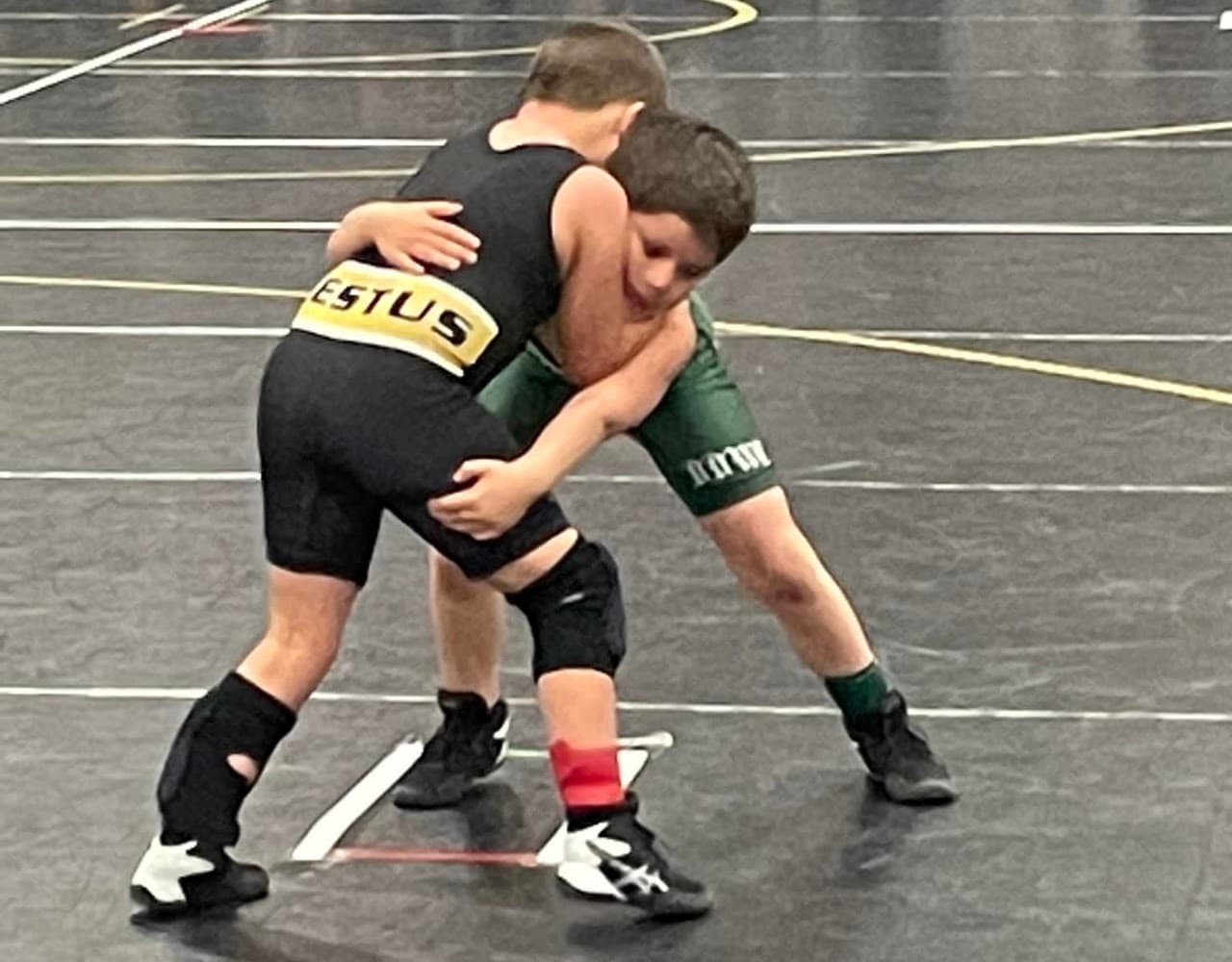 Two Festus youth wrestlers competing on the mat