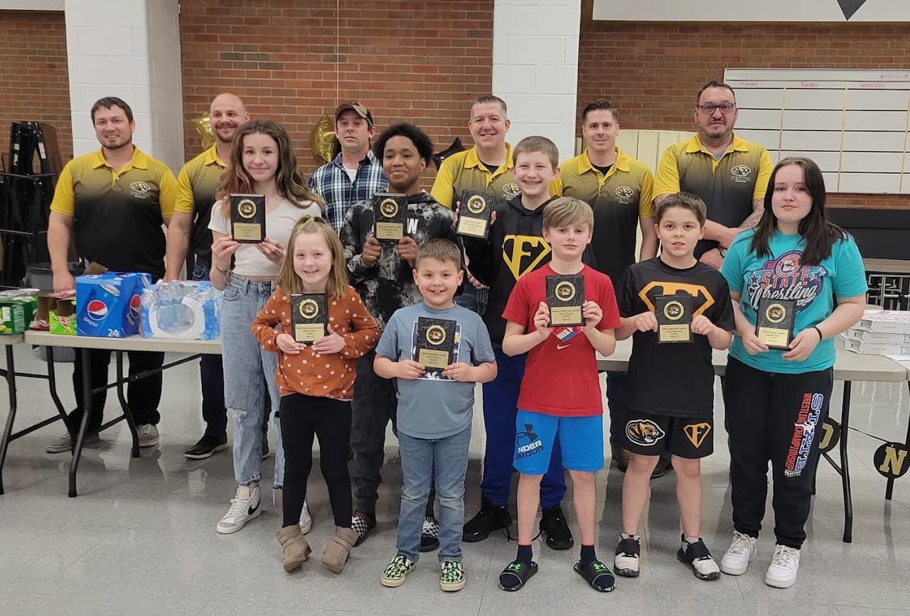 Festus Youth Wrestling Club athletes and coaches celebrating awards